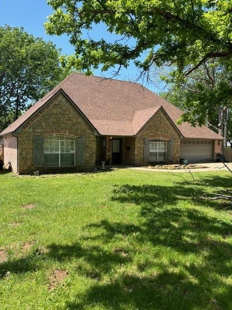 501 S 7th St, Okemah, OK 74859 - single story home featuring a front lawn, driveway, stone siding, and an attached garage