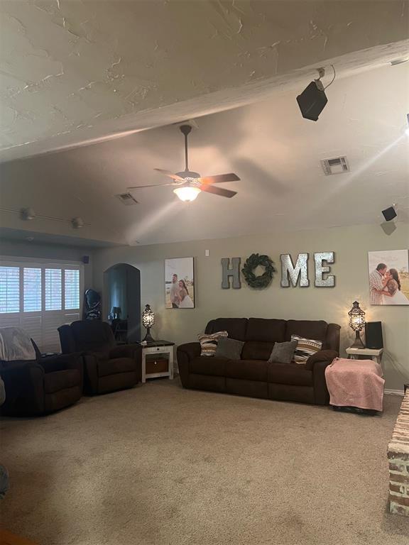 501 S 7th St, Okemah, OK 74859 - carpeted living room featuring ceiling fan and visible vents