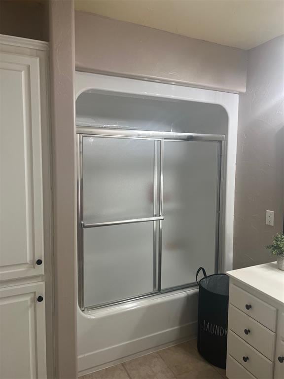 501 S 7th St, Okemah, OK 74859 - full bathroom with tile patterned floors, vanity, and shower / bath combination with glass door