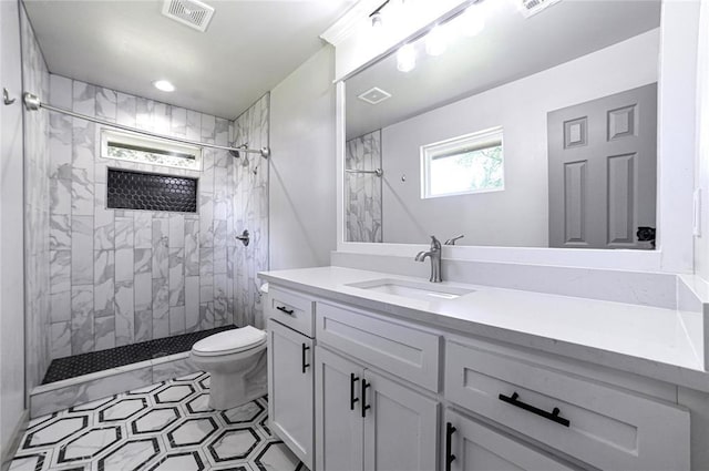 1717 Breckenridge Dr, Oklahoma City, OK 73115 - full bathroom with a tile shower, toilet, vanity, and visible vents