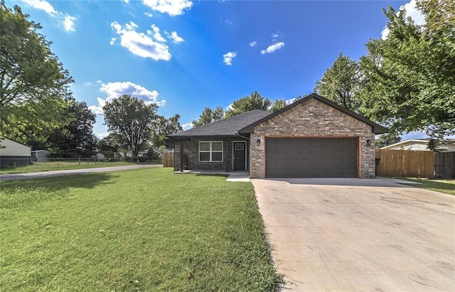 1717 Breckenridge Dr, Oklahoma City, OK 73115 - view of front facade featuring concrete driveway, fence, brick siding, an attached garage, and a front yard