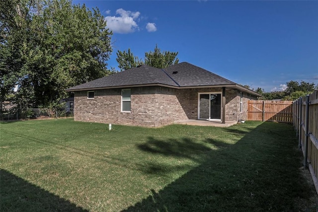 1717 Breckenridge Dr, Oklahoma City, OK 73115 - rear view of house with a lawn, a fenced backyard, brick siding, and a patio area