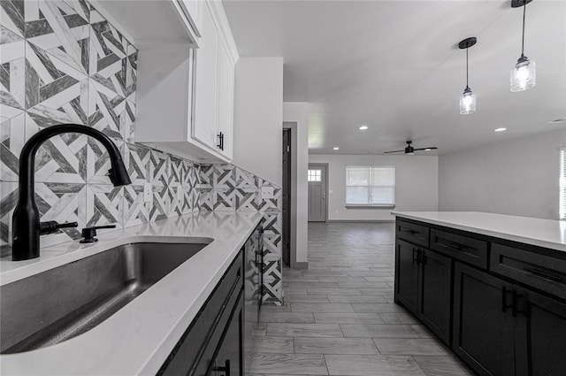 1717 Breckenridge Dr, Oklahoma City, OK 73115 - kitchen featuring dark cabinets, a sink, white cabinetry, and recessed lighting