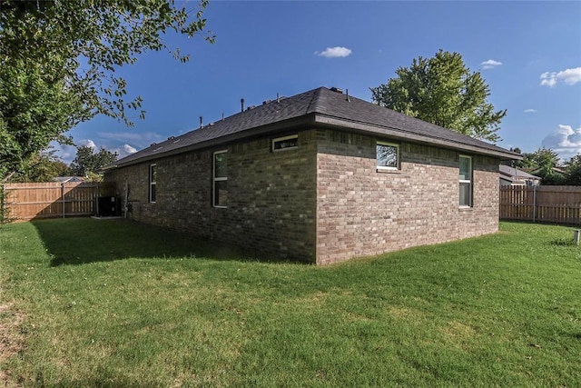 1717 Breckenridge Dr, Oklahoma City, OK 73115 - view of home's exterior with brick siding, a lawn, and a fenced backyard