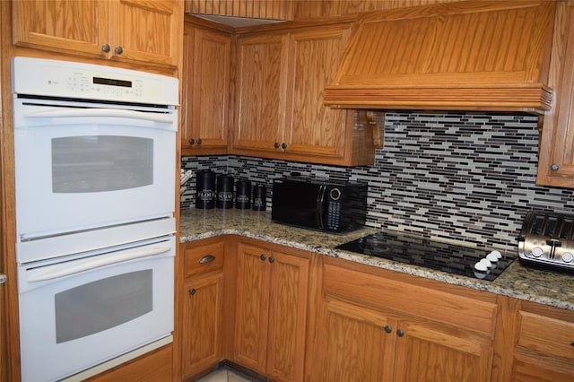 1400 S Indian Meridian Rd, Choctaw, OK 73020 - kitchen with tasteful backsplash, stone countertops, custom range hood, and black appliances