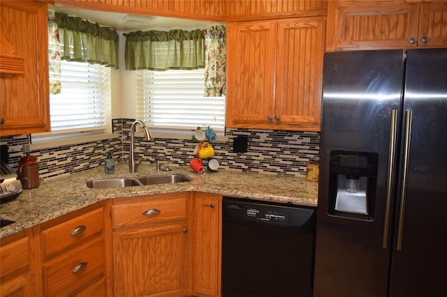 1400 S Indian Meridian Rd, Choctaw, OK 73020 - kitchen featuring a sink, tasteful backsplash, brown cabinets, light stone counters, and black appliances