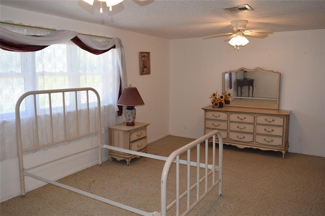 1400 S Indian Meridian Rd, Choctaw, OK 73020 - carpeted bedroom with a textured ceiling, visible vents, and ceiling fan
