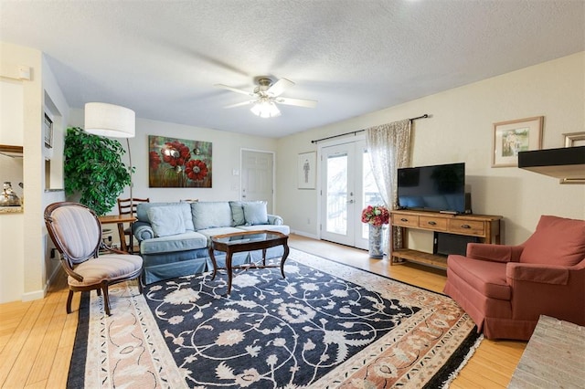 3200 W Britton Rd Unit 232, Oklahoma City, OK 73120 - living area featuring wood finished floors, ceiling fan, and a textured ceiling