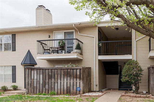 3200 W Britton Rd Unit 232, Oklahoma City, OK 73120 - rear view of property with a balcony and a chimney