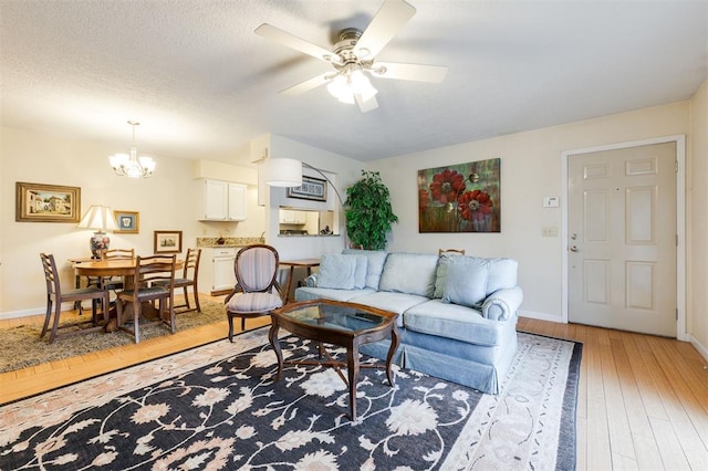 3200 W Britton Rd Unit 232, Oklahoma City, OK 73120 - living room featuring light wood-style floors, a chandelier, and a ceiling fan