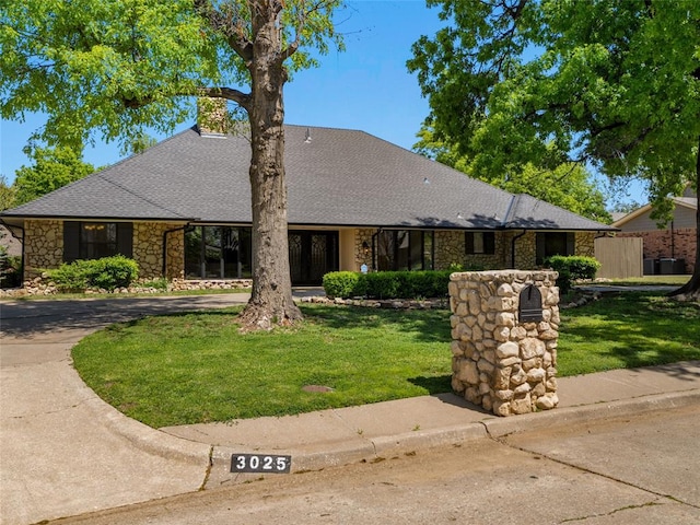 3025 Pine Ridge Rd, Oklahoma City, OK 73120 - single story home featuring a front lawn, roof with shingles, and stone siding