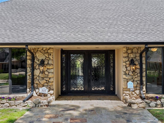 3025 Pine Ridge Rd, Oklahoma City, OK 73120 - property entrance featuring roof with shingles and stone siding