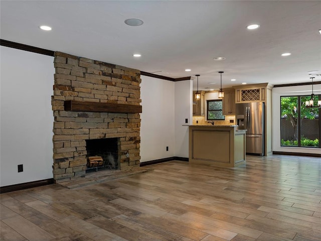 3025 Pine Ridge Rd, Oklahoma City, OK 73120 - unfurnished living room with wood finished floors, baseboards, a fireplace, and crown molding