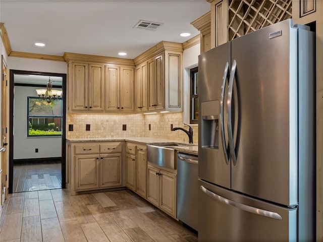3025 Pine Ridge Rd, Oklahoma City, OK 73120 - kitchen with a sink, tasteful backsplash, a notable chandelier, light stone countertops, and appliances with stainless steel finishes