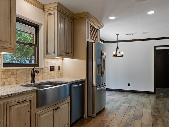 3025 Pine Ridge Rd, Oklahoma City, OK 73120 - kitchen featuring light stone counters, stainless steel appliances, visible vents, a sink, and decorative backsplash