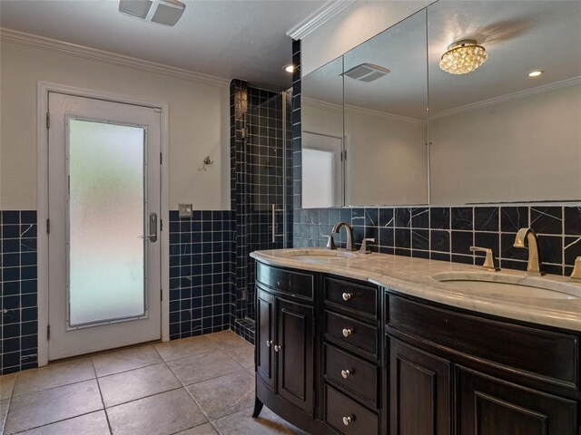 3025 Pine Ridge Rd, Oklahoma City, OK 73120 - bathroom featuring double vanity, tile walls, tile patterned floors, and a sink