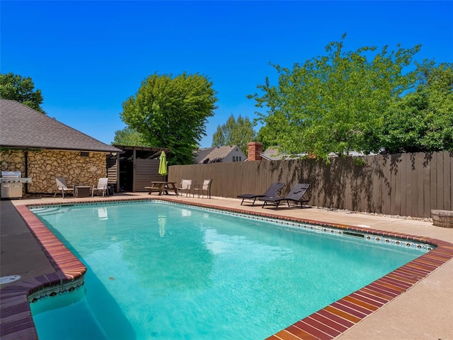 3025 Pine Ridge Rd, Oklahoma City, OK 73120 - view of pool featuring fence, a patio area, a fenced in pool, and a grill