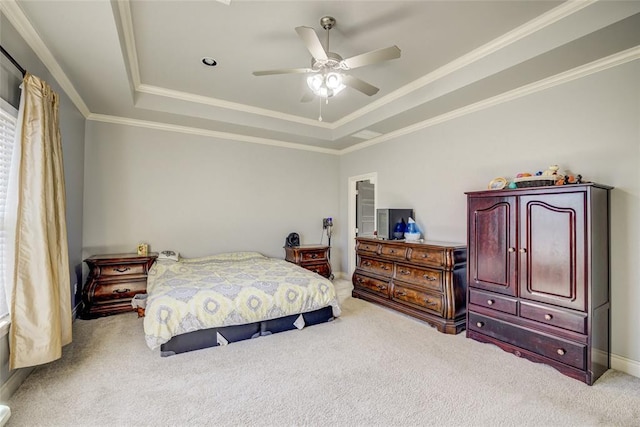 bedroom featuring a raised ceiling, ornamental molding, carpet floors, baseboards, and ceiling fan