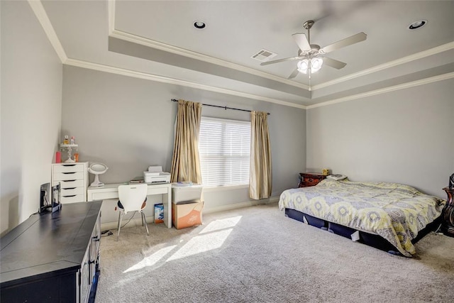 carpeted bedroom featuring visible vents, baseboards, a tray ceiling, and crown molding
