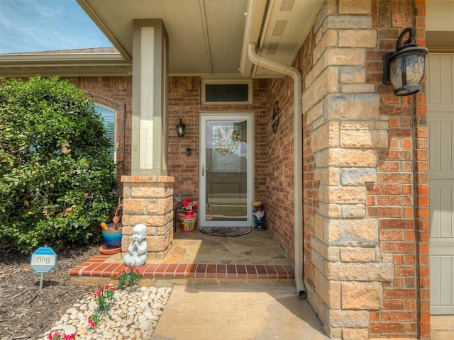 property entrance featuring a porch and brick siding