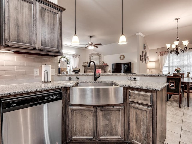 kitchen with dark brown cabinets, a sink, ceiling fan with notable chandelier, decorative backsplash, and dishwasher