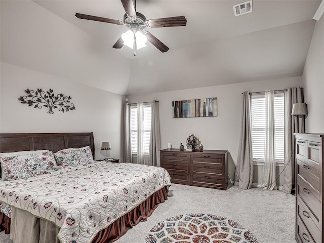 carpeted bedroom with lofted ceiling, visible vents, a ceiling fan, and baseboards