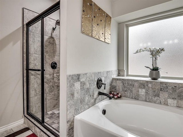 bathroom with a shower stall and a garden tub