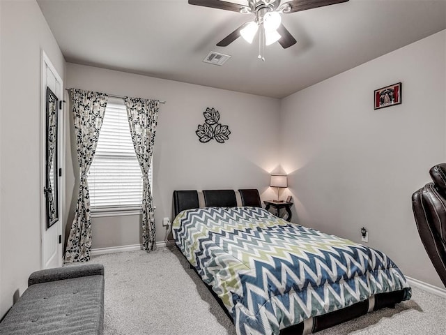 bedroom with baseboards, a ceiling fan, visible vents, and carpet flooring