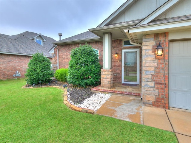18232 Scarborough Dr, Edmond, OK 73012 - property entrance with a yard, brick siding, roof with shingles, and a garage