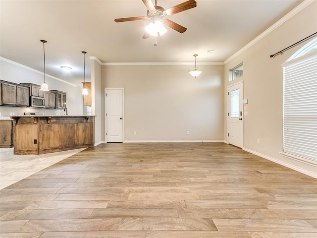 18232 Scarborough Dr, Edmond, OK 73012 - unfurnished living room with light wood-style floors, ornamental molding, and a ceiling fan
