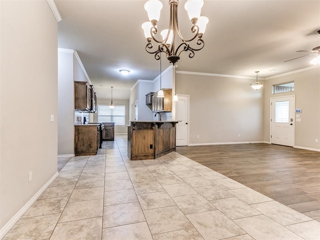 18232 Scarborough Dr, Edmond, OK 73012 - kitchen featuring crown molding, a chandelier, pendant lighting, a ceiling fan, and open floor plan