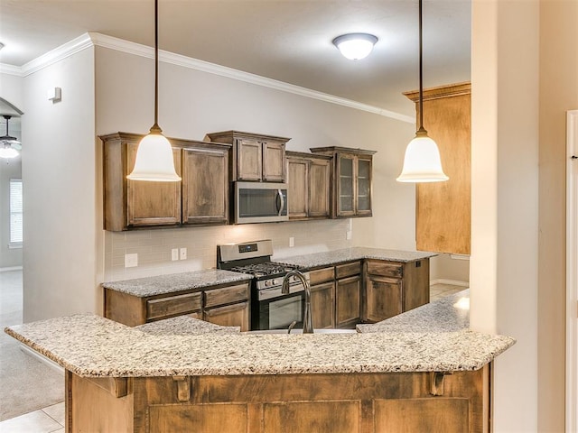 18232 Scarborough Dr, Edmond, OK 73012 - kitchen featuring appliances with stainless steel finishes, crown molding, light stone counters, backsplash, and pendant lighting