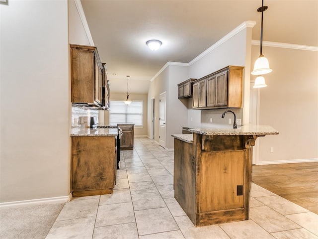 18232 Scarborough Dr, Edmond, OK 73012 - kitchen featuring a peninsula, light stone countertops, stainless steel gas range oven, a breakfast bar, and crown molding