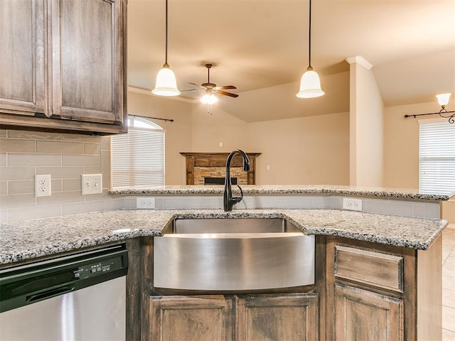 18232 Scarborough Dr, Edmond, OK 73012 - kitchen with stainless steel dishwasher, ceiling fan, backsplash, hanging light fixtures, and lofted ceiling