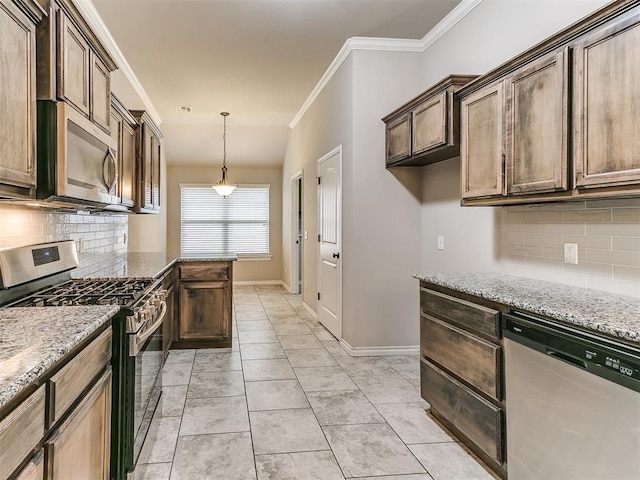18232 Scarborough Dr, Edmond, OK 73012 - kitchen with appliances with stainless steel finishes, decorative backsplash, light stone counters, hanging light fixtures, and ornamental molding