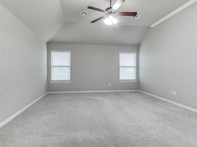 18232 Scarborough Dr, Edmond, OK 73012 - empty room with vaulted ceiling, plenty of natural light, a ceiling fan, and carpet flooring