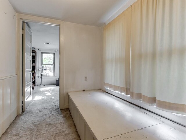 corridor featuring visible vents and light colored carpet