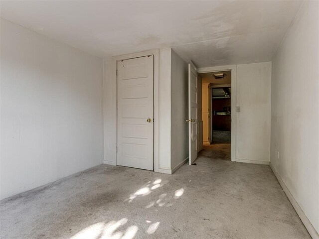 unfurnished bedroom with baseboards and carpet flooring