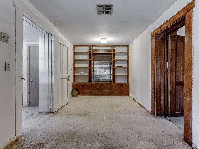 spare room with carpet floors and visible vents