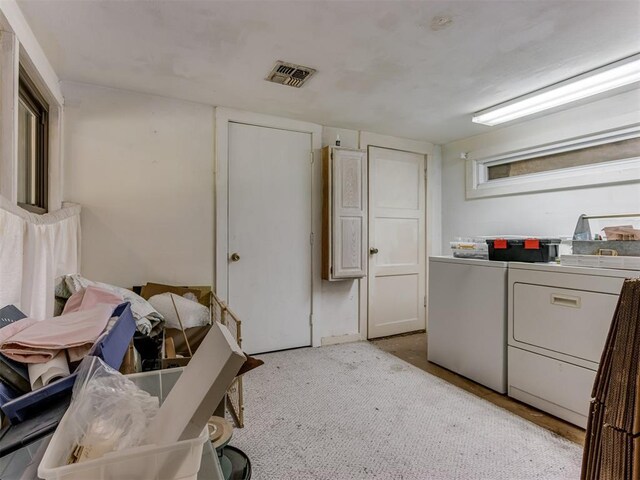 laundry room with washer and dryer, laundry area, and visible vents