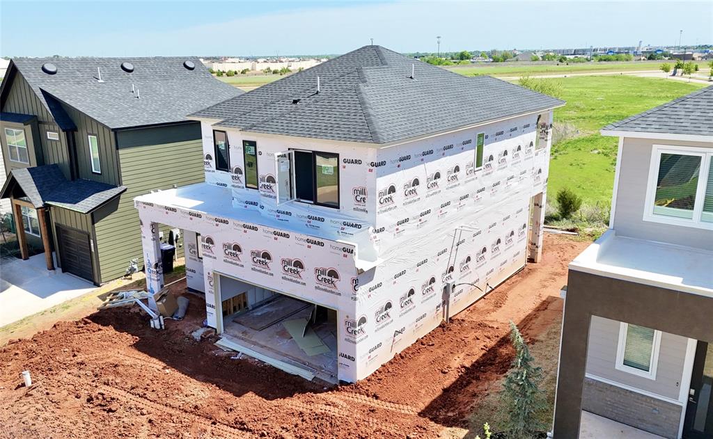 view of side of home featuring roof with shingles