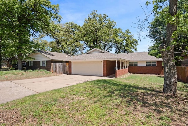 ranch-style home with concrete driveway, fence, brick siding, a garage, and a front yard