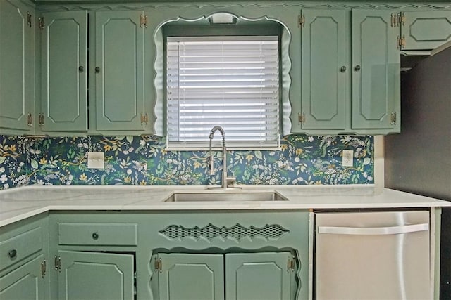 kitchen featuring wallpapered walls, dishwasher, a sink, and green cabinets