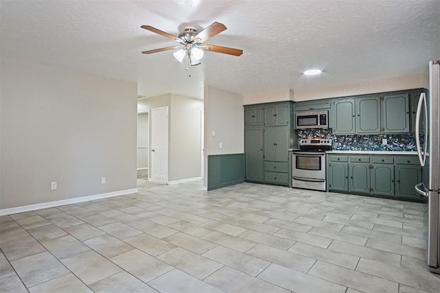 kitchen with green cabinetry, stainless steel appliances, decorative backsplash, a textured ceiling, and ceiling fan
