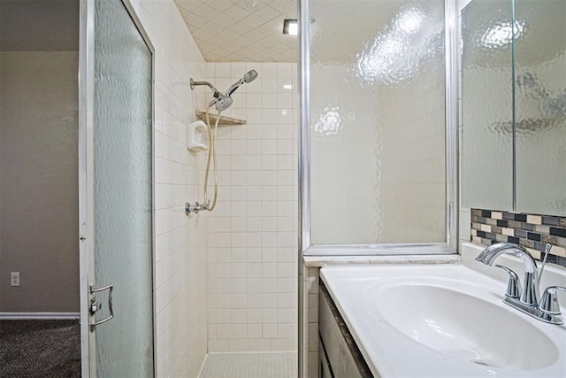 bathroom with a shower stall and vanity