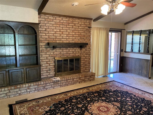 unfurnished living room with a ceiling fan and a fireplace
