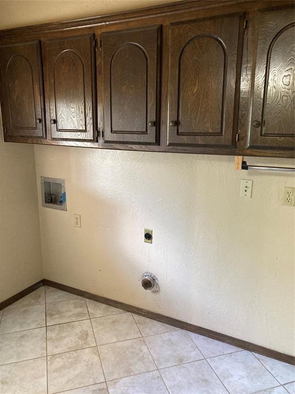 laundry room with cabinet space, washer hookup, baseboards, light tile patterned floors, and electric dryer hookup