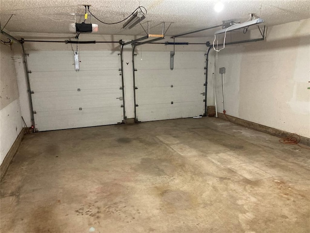 garage featuring a garage door opener and baseboards