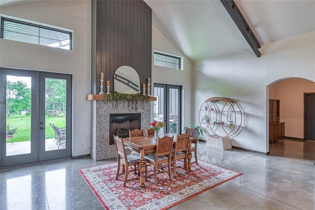 25478 Sooner Ave, Purcell, OK 73080 - dining room with french doors, high vaulted ceiling, arched walkways, a fireplace, and beam ceiling