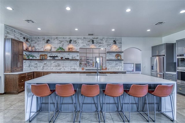 25478 Sooner Ave, Purcell, OK 73080 - kitchen with open shelves, stainless steel appliances, backsplash, finished concrete floors, and recessed lighting